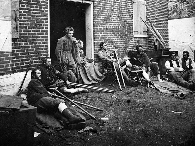 Soldiers resting outside a field hospital